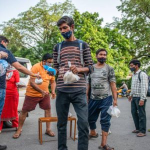 NEW DELHI, INDIA - 2021/05/31: A young man receives a food package and a facemask during food distribution by the Baba Balak Nath Mandir Hindu institution.
The Baba Balak Nath Mandir, Hindu devotees distribute food packages and masks to daily wagers, homeless and other people affected by the Covid-19 lockdown at Gol Dak Khana Roundabout. (Photo by Pradeep Gaur/SOPA Images/LightRocket via Getty Images)
